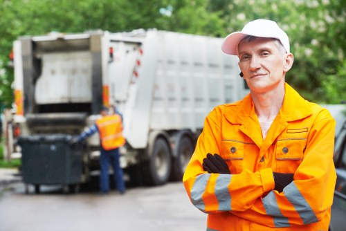 Operatives securing and loading garden waste onto a covered vehicle
